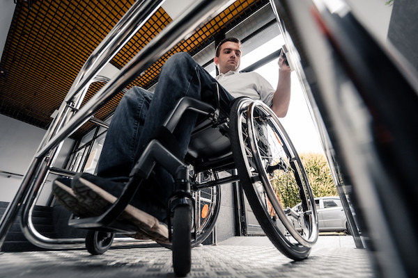 A young man in a wheelchair boards an accessible train