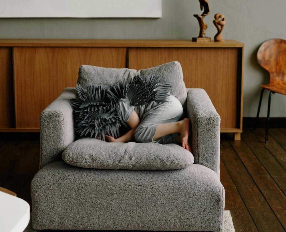 Child hiding on a couch