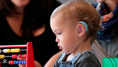 Child with hearing impediment learning to play