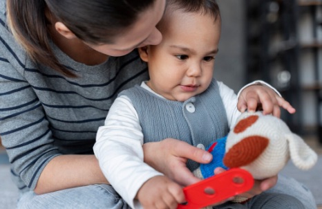 Mother cuddling her. toddler