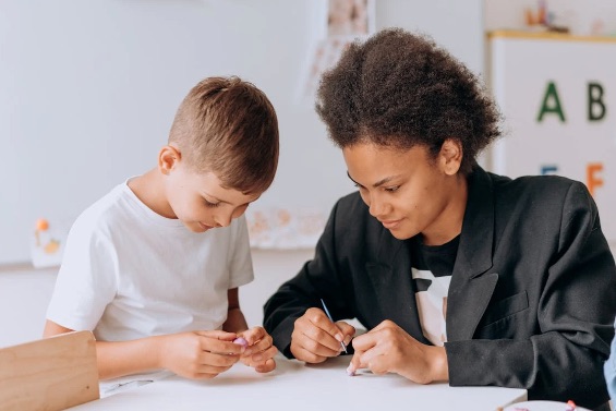 a little boy being tutored by a speech therapist