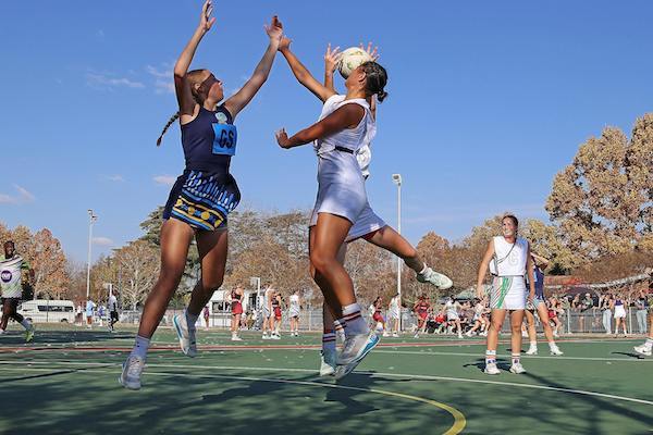 Two woman playing Netball
