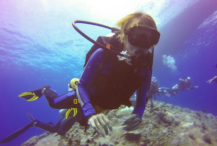 Blind scuba diver with guide