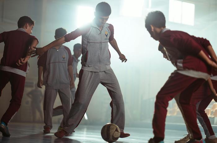 young boys playing foozball